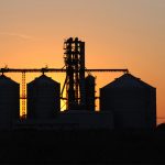 Silhouette of a grain elevator at sunset