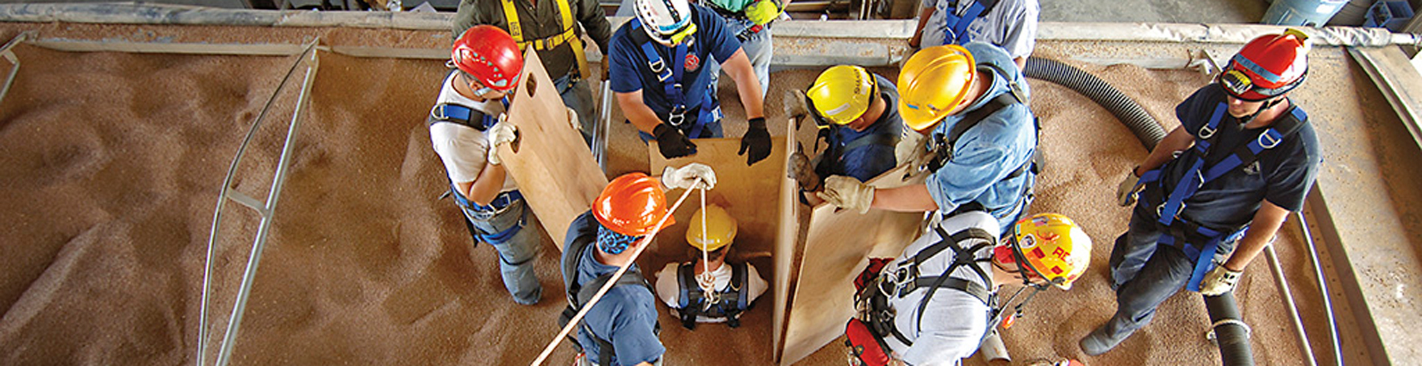 Firefighters walking through a grain bin rescue exercise