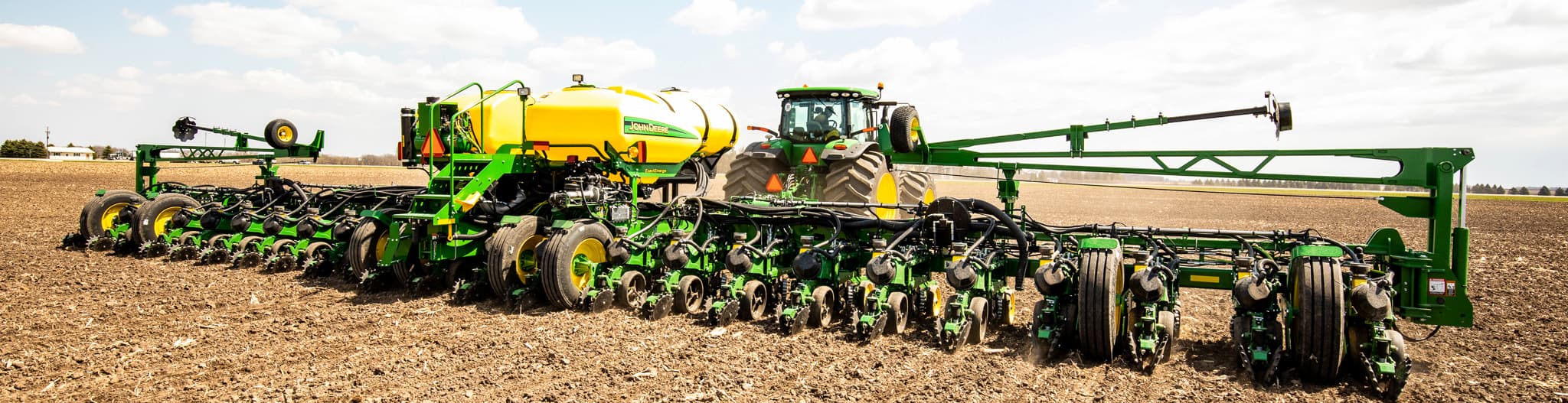 Tractor pulling a planter through the field