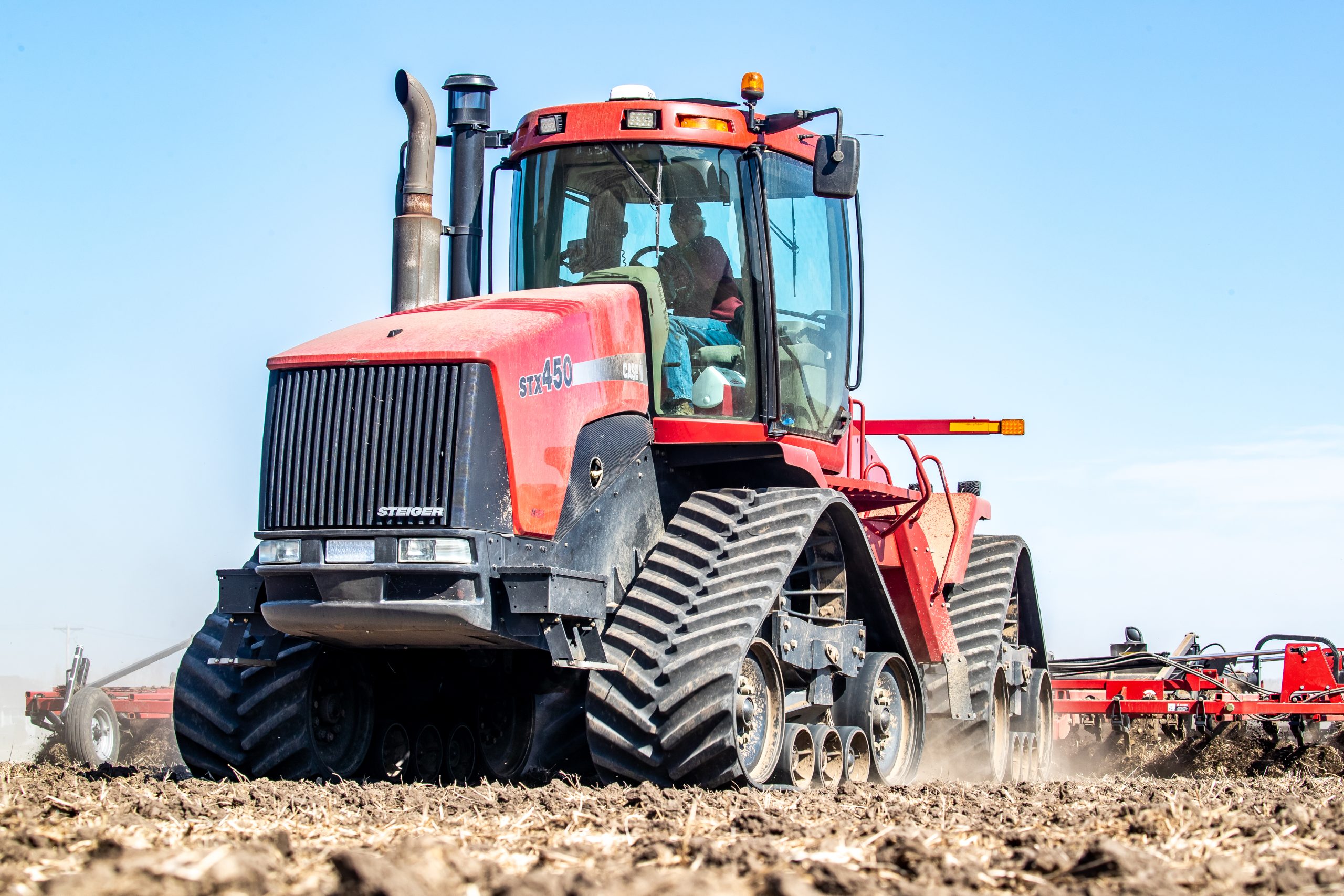 Tractor pulling a tiller through a field