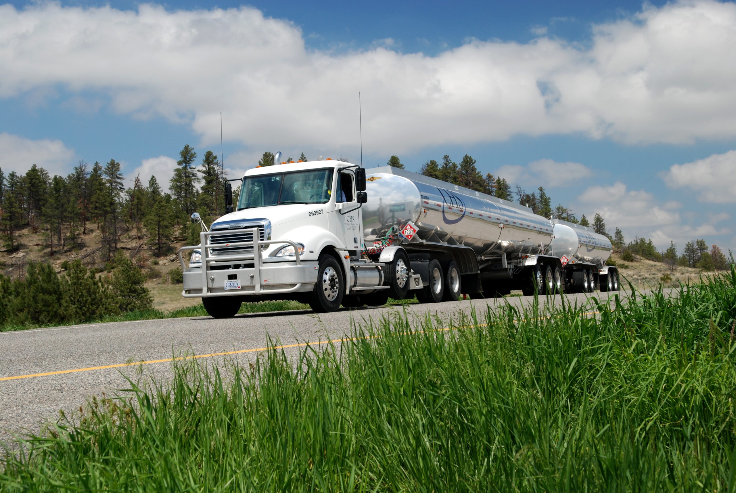 CHS propane semi truck driving down a road